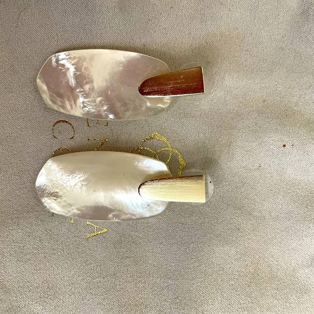 Kendra Scott mother of pearl and gold earrings.